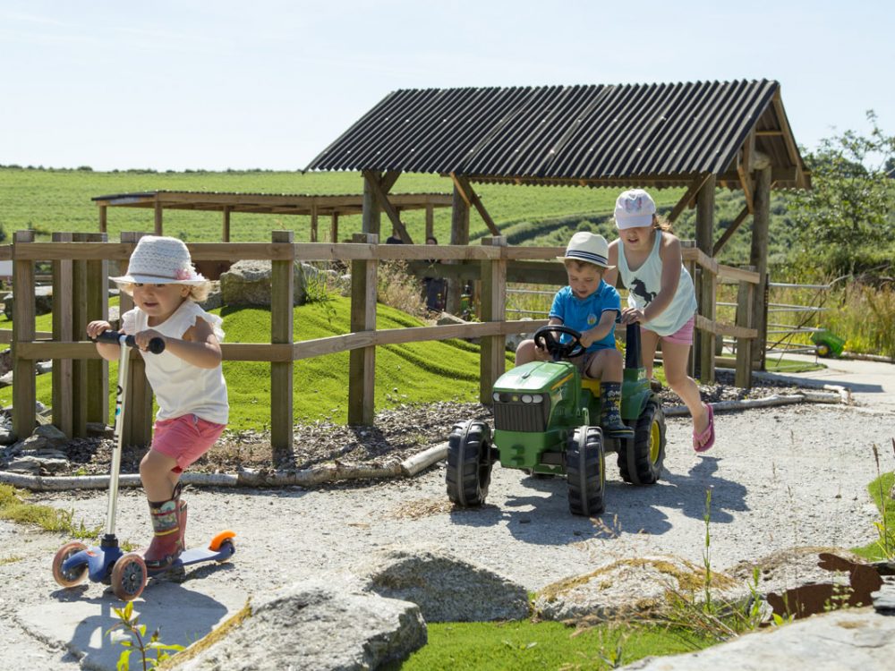 3 children racing around the Balance Bike Track at Tredethick